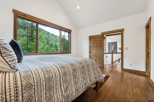 a bedroom with a large bed and a large window