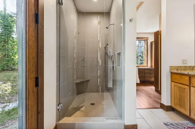 a bathroom with a tub shower and sink