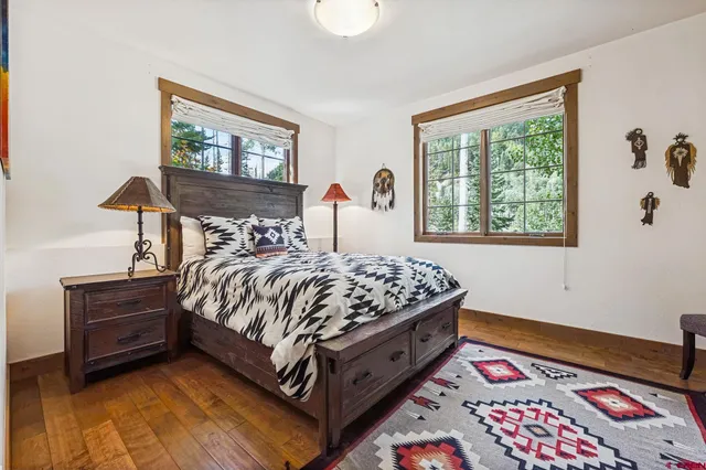 a bed sitting in a bedroom next to a window
