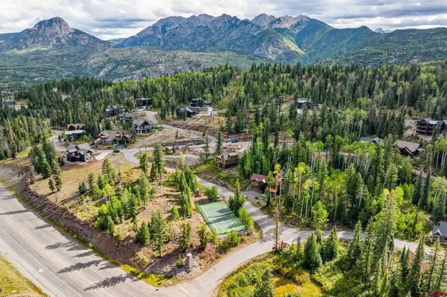 a view of a lush green hillside and houses