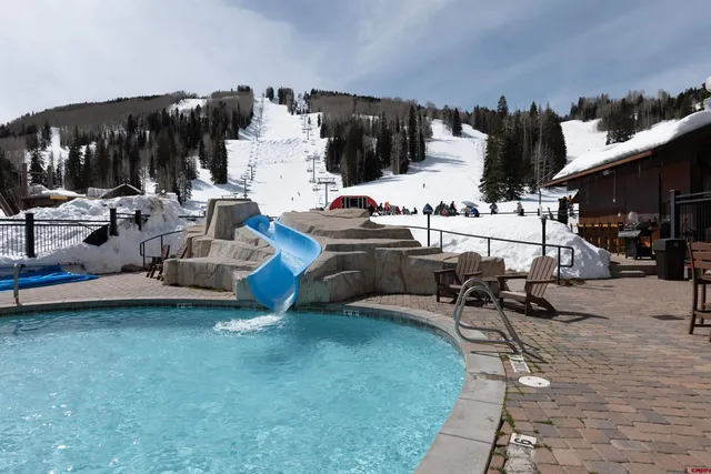 a view of a swimming pool and lounge chairs