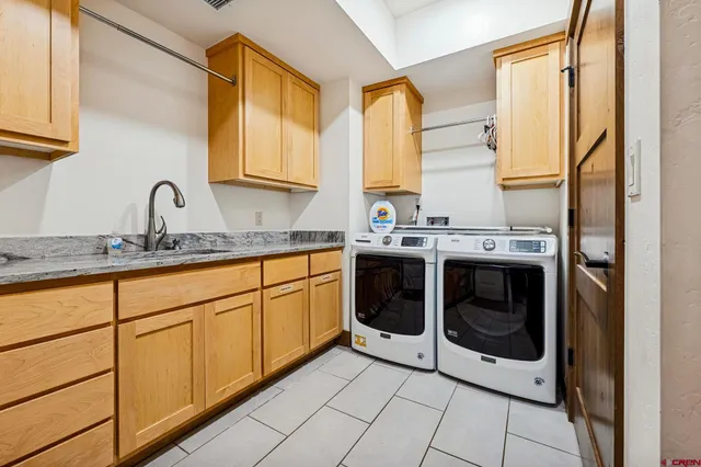 a kitchen with stainless steel appliances granite countertop a sink and a stove next to a window