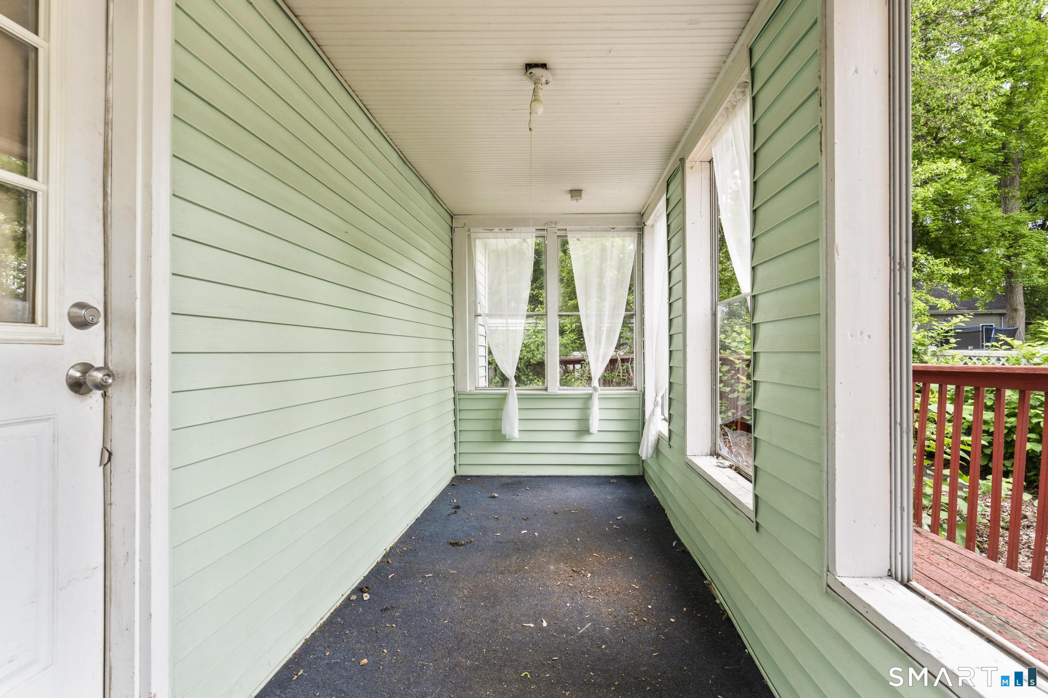 101 Meridian Street Meriden, CT 06451 - Photo 3 of 26 a view of a porch with wooden floor and deck