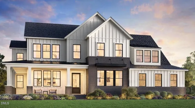 a front view of residential houses with yard and green space