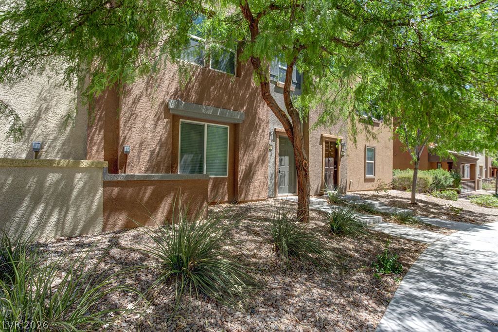 4650 Ranch House Road, Unit 47 North Las Vegas, NV 89031 - Photo 38 of 43 A well-maintained facade features mature trees and low-maintenance landscaping, enhancing curb appeal.