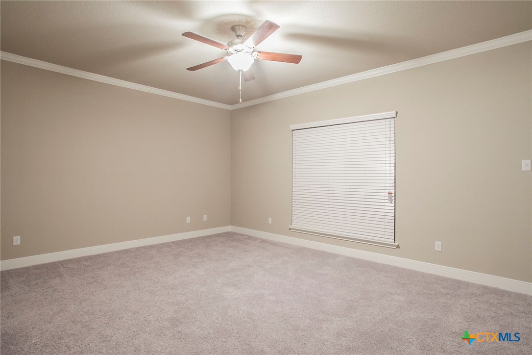 549 Wills Point Way Belton, TX 76513 - Photo 27 of 31 an empty room with a chandelier fan and windows