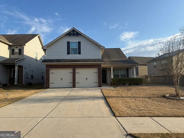 a front view of a house with yard
