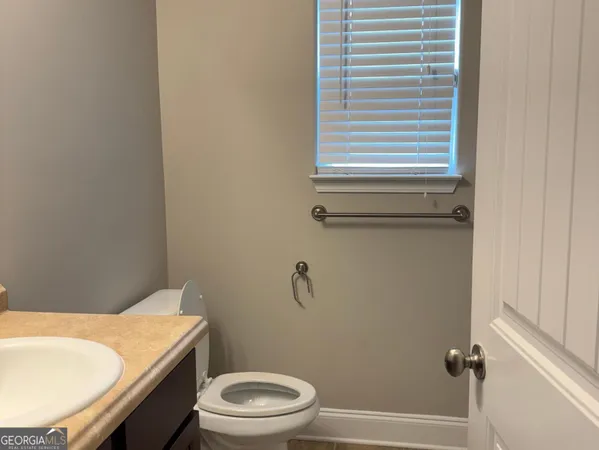 a white toilet sitting next to a bathroom sink