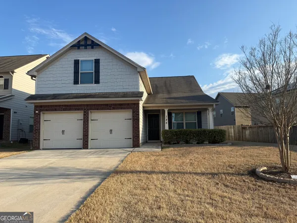 a front view of a house with a yard