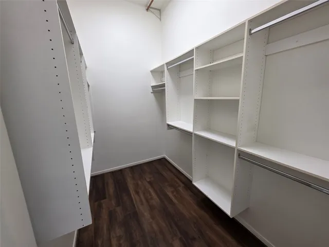 a view of walk in closet with empty racks