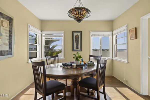a view of a dining room with furniture window and wooden floor