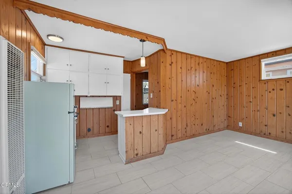 a view of a kitchen with cabinets and wooden floor
