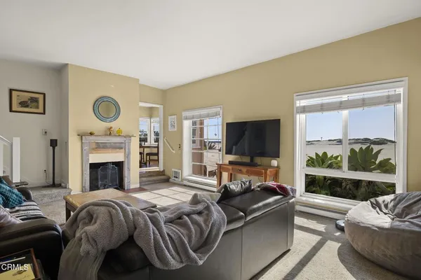 a living room with furniture fireplace and flat screen tv