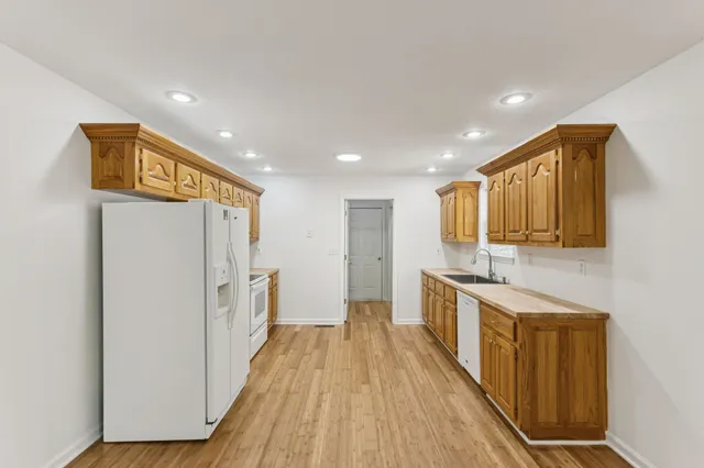 a view of a kitchen with a sink and wooden floor