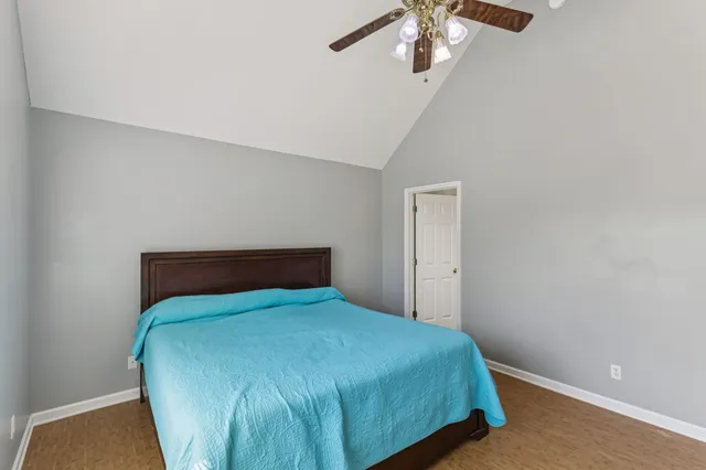 a bedroom with a bed and a chandelier