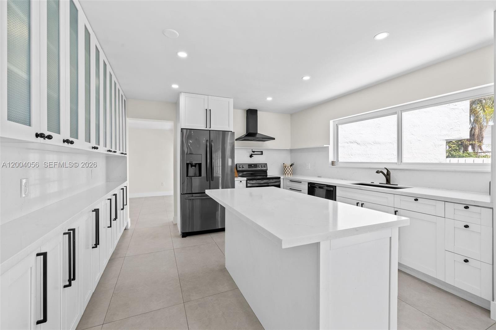9547 Southwest 146th Place Miami, FL 33186 - Photo 13 of 40 a kitchen with white cabinets and refrigerator