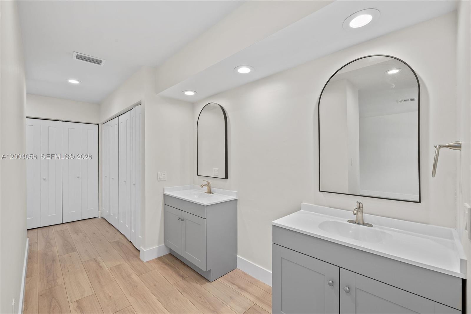 9547 Southwest 146th Place Miami, FL 33186 - Photo 24 of 40 a en suite bathroom with a double vanity sink and mirror