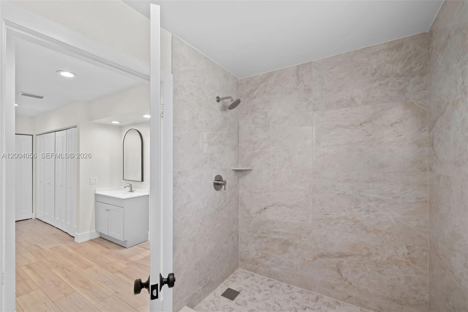 9547 Southwest 146th Place Miami, FL 33186 - Photo 25 of 40 a bathroom with a sink a toilet and shower