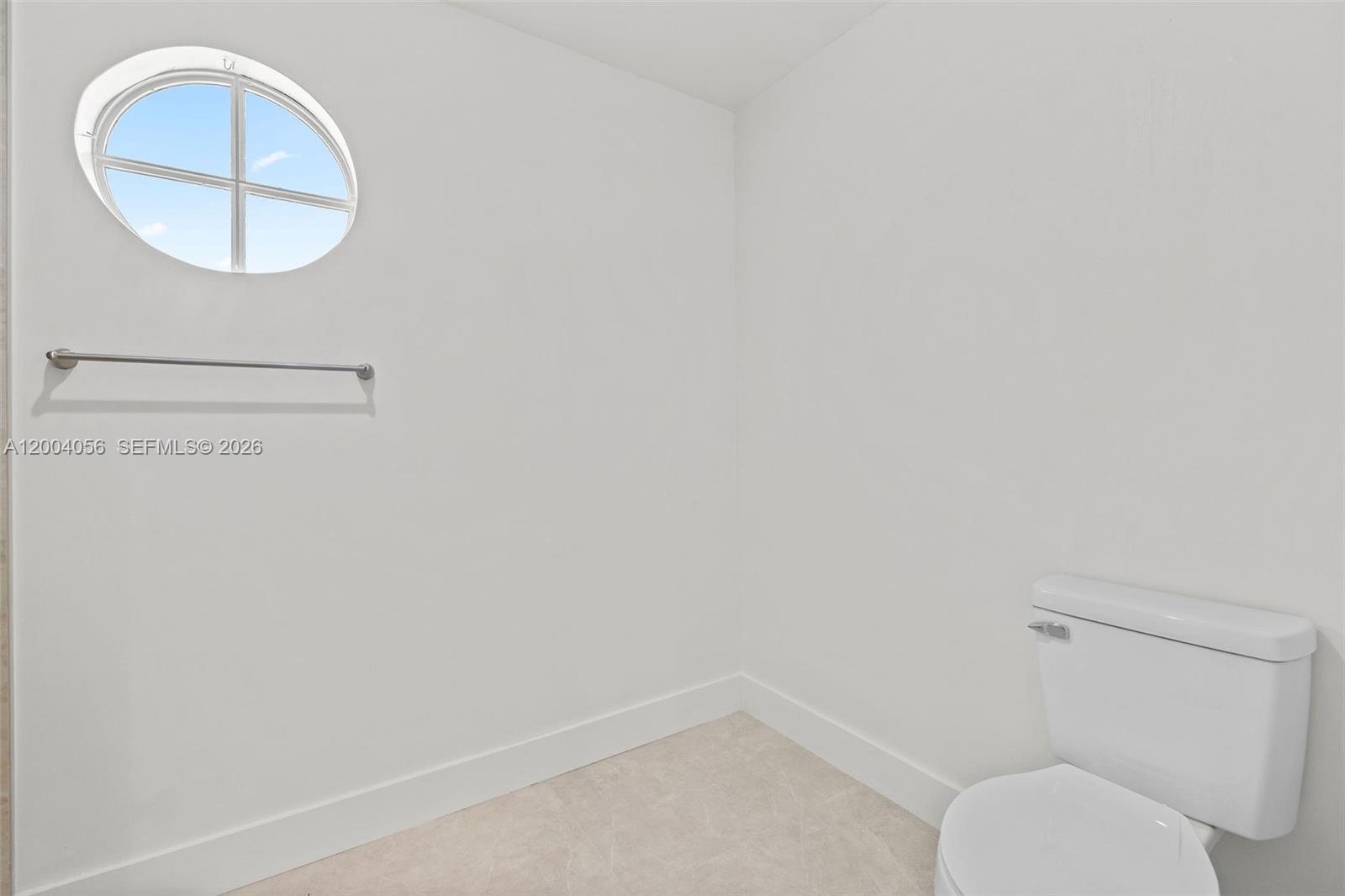 9547 Southwest 146th Place Miami, FL 33186 - Photo 26 of 40 a bathroom with a toilet and a mirror