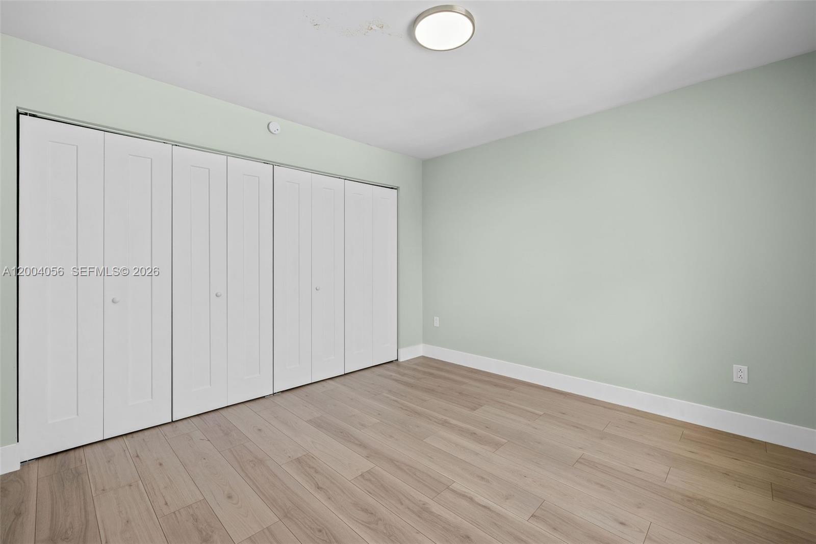 9547 Southwest 146th Place Miami, FL 33186 - Photo 29 of 40 a view of an empty room with wooden floor