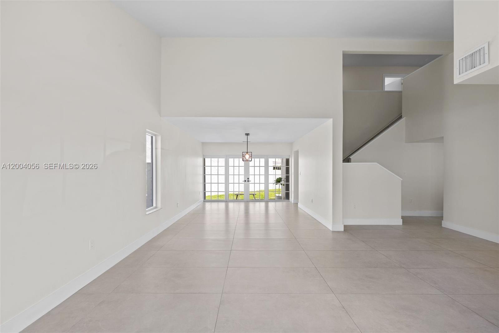 9547 Southwest 146th Place Miami, FL 33186 - Photo 3 of 40 a view of an empty room with a window