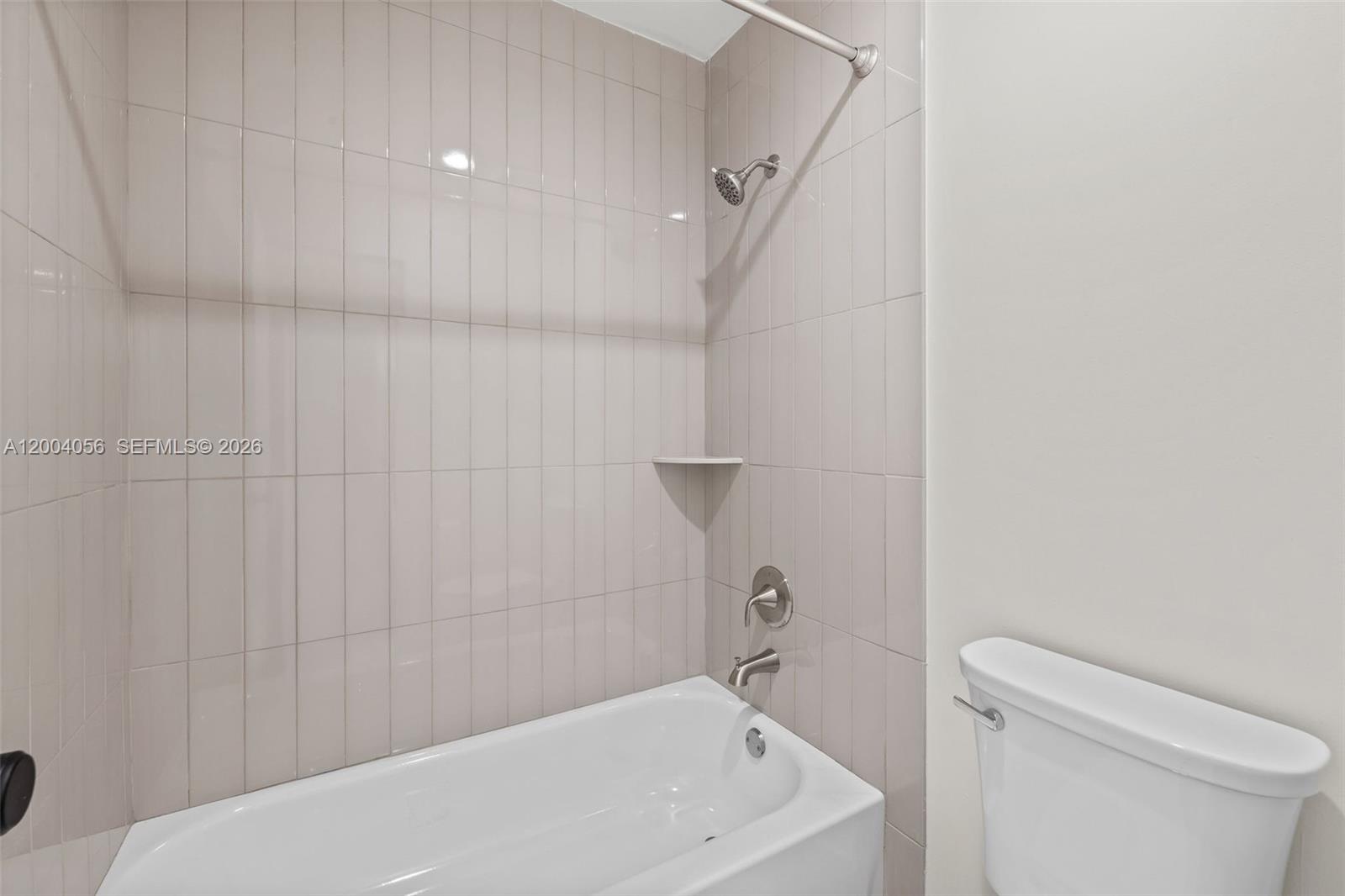 9547 Southwest 146th Place Miami, FL 33186 - Photo 32 of 40 a bathroom with a sink a toilet and shower
