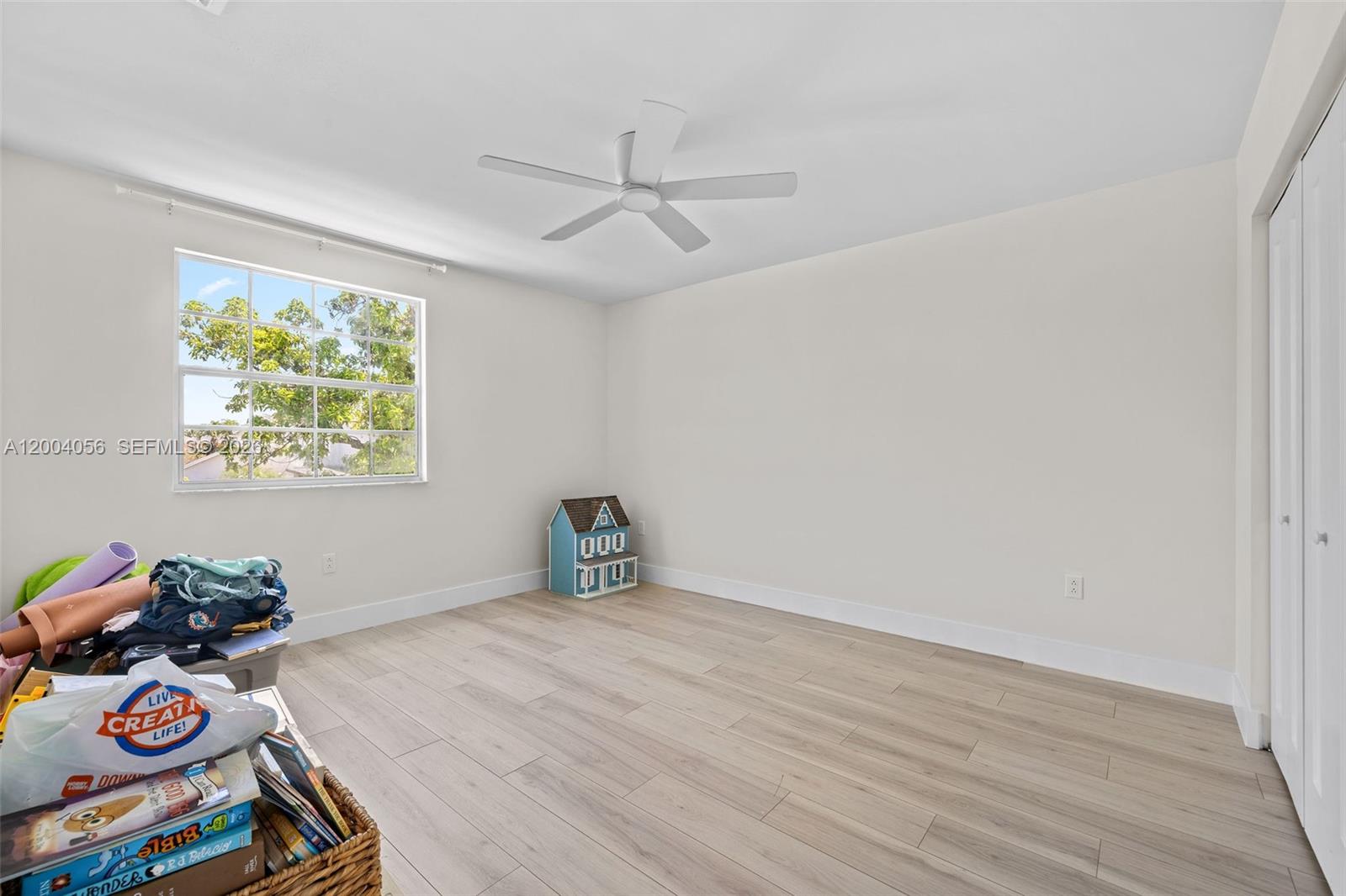 9547 Southwest 146th Place Miami, FL 33186 - Photo 33 of 40 a view of an empty room with window and wooden floor