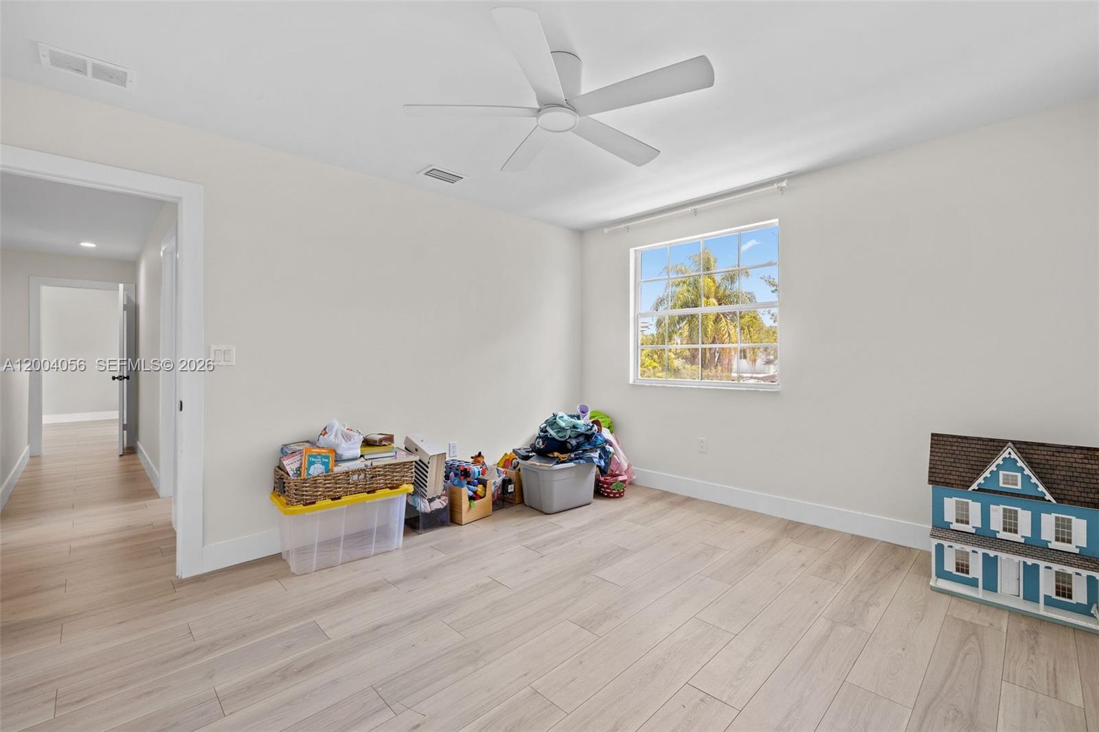 9547 Southwest 146th Place Miami, FL 33186 - Photo 34 of 40 a room with wooden floor and ceiling fan