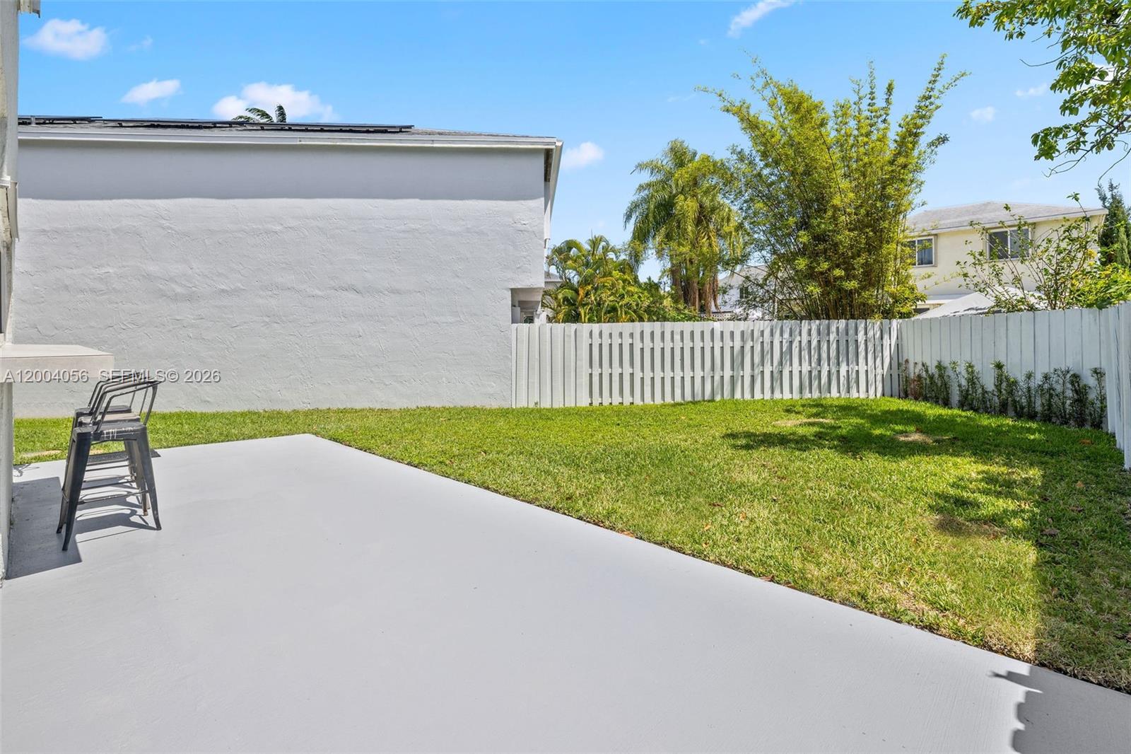 9547 Southwest 146th Place Miami, FL 33186 - Photo 36 of 40 a view of a backyard with a garden and deck
