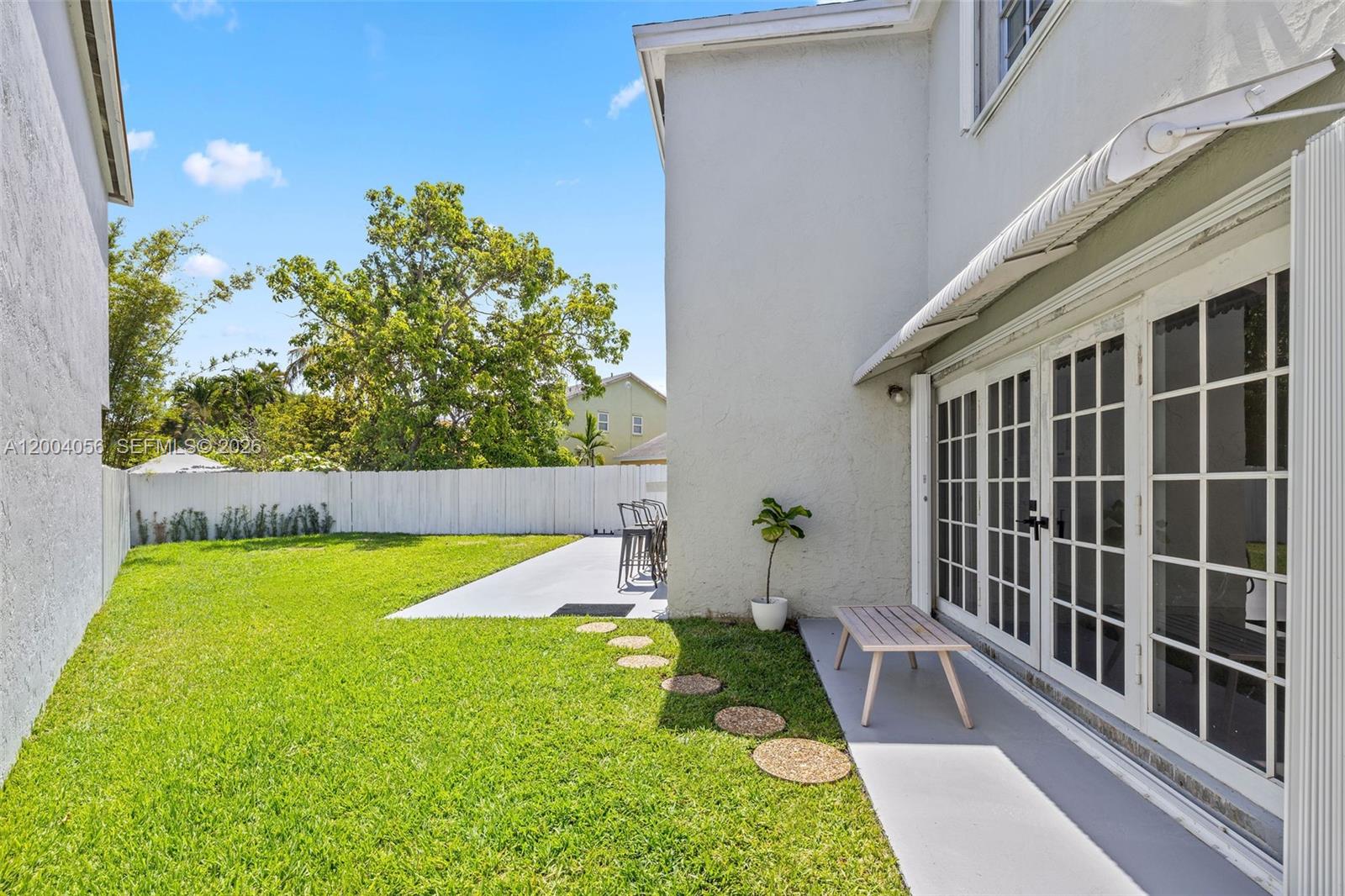 9547 Southwest 146th Place Miami, FL 33186 - Photo 38 of 40 a view of a house with a yard and a patio