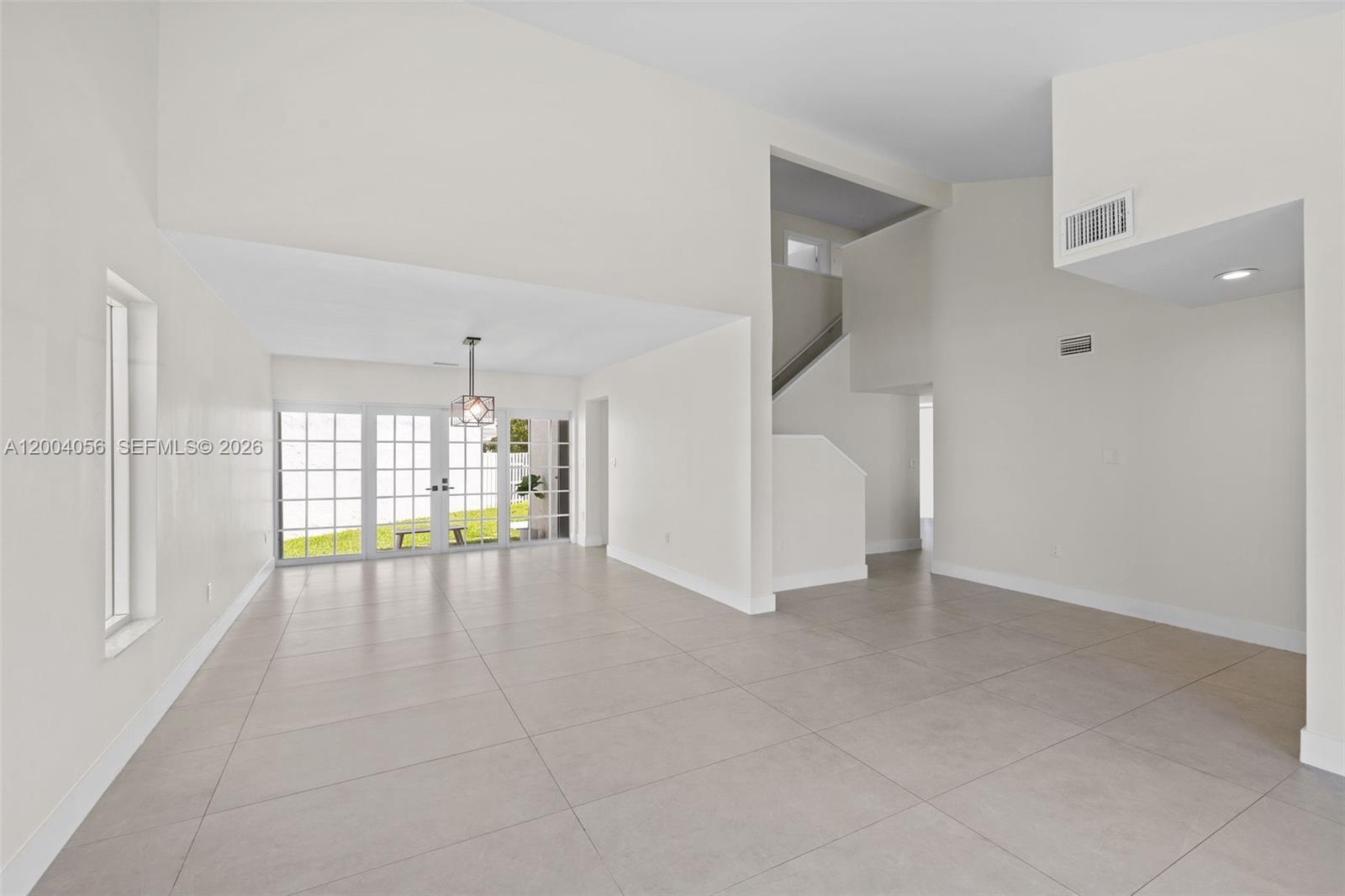 9547 Southwest 146th Place Miami, FL 33186 - Photo 4 of 40 a view of an empty room with a window