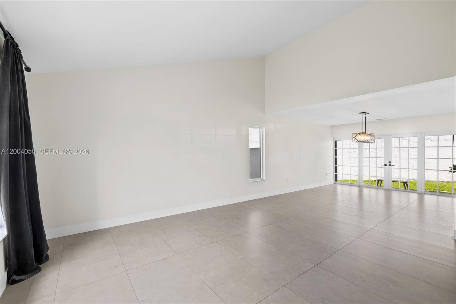 9547 Southwest 146th Place Miami, FL 33186 - Photo 5 of 40 a view of an empty room with a window