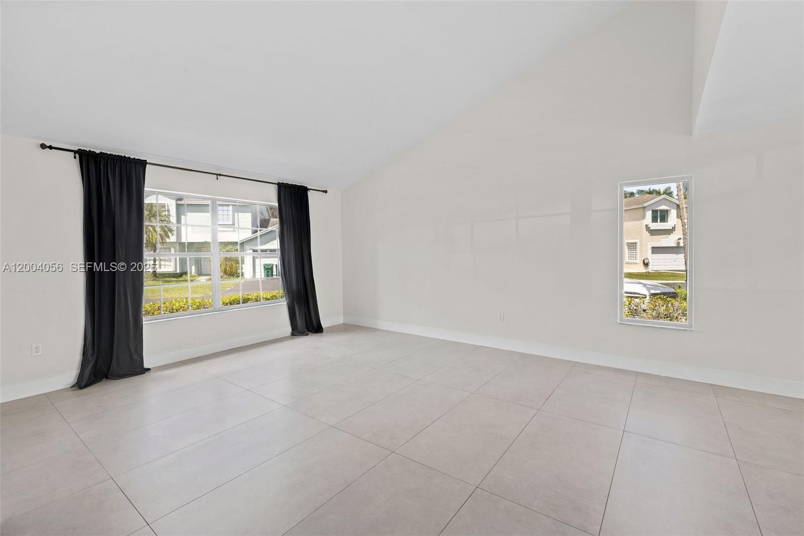 9547 Southwest 146th Place Miami, FL 33186 - Photo 6 of 40 a view of an empty room with a window