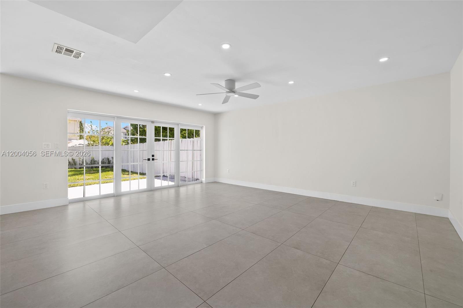 9547 Southwest 146th Place Miami, FL 33186 - Photo 9 of 40 a view of an empty room with a window