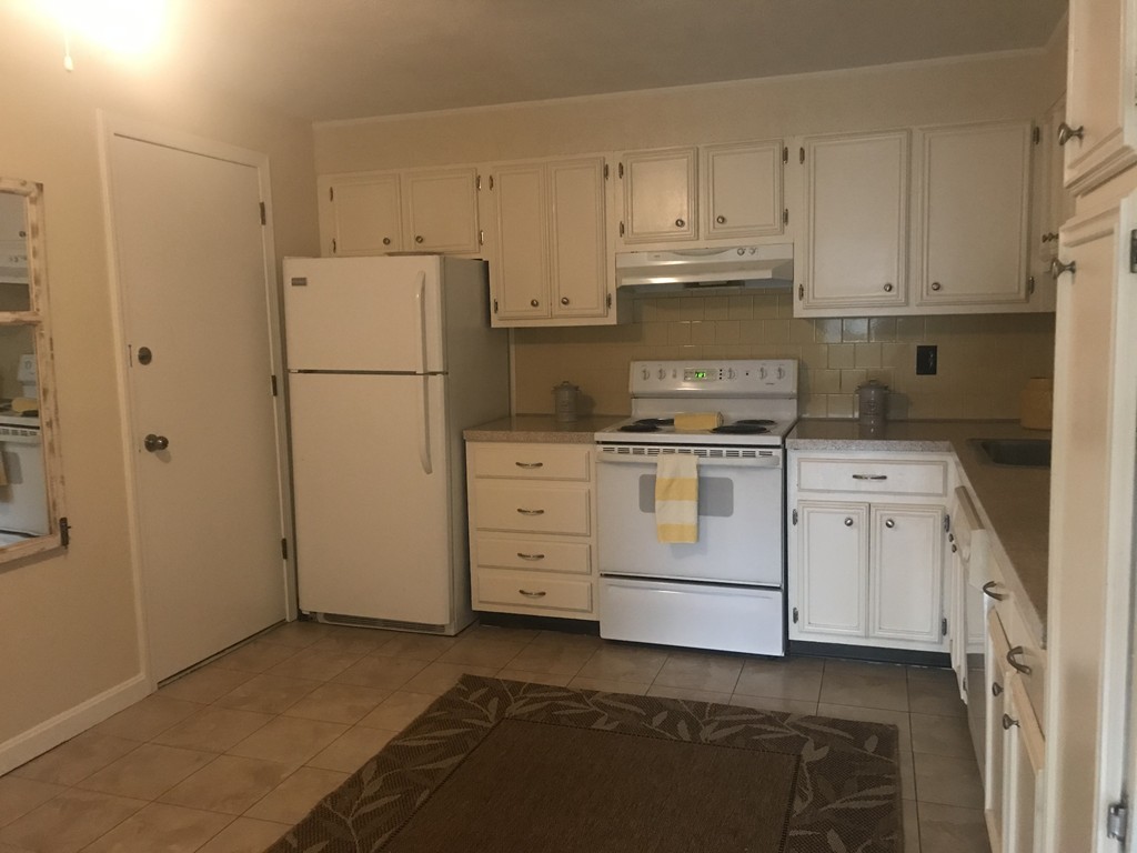 120 Parker Street, Unit 25 Acton, MA 01720 - Photo 2 of 11 a kitchen with cabinets appliances and a refrigerator