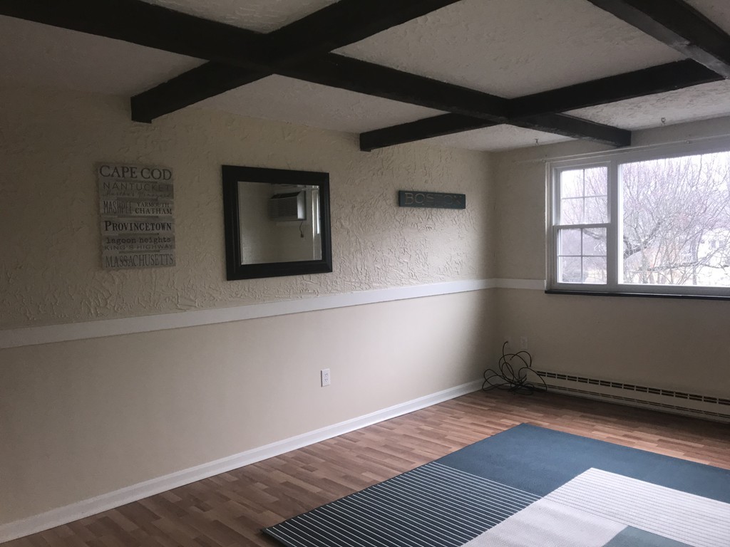 120 Parker Street, Unit 25 Acton, MA 01720 - Photo 4 of 11 a view of an empty room with wooden floor and a window