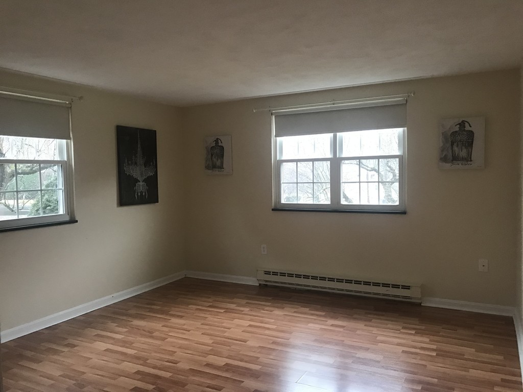 120 Parker Street, Unit 25 Acton, MA 01720 - Photo 6 of 11 a view of a room with wooden floor and windows