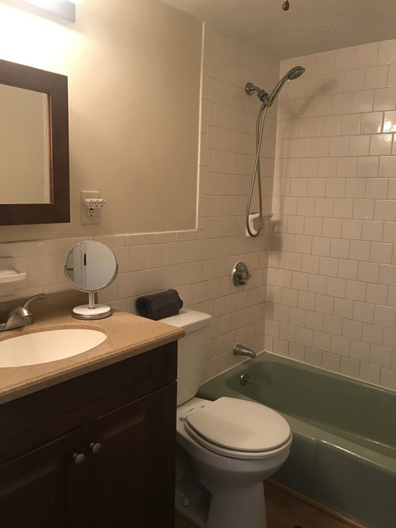 120 Parker Street, Unit 25 Acton, MA 01720 - Photo 10 of 11 a bathroom with a sink a toilet and shower