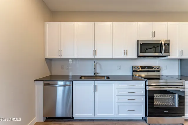 a kitchen with kitchen island a sink and a stove top oven
