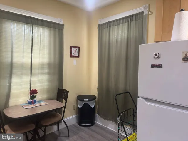 a view of a workspace room with furniture and wooden floor