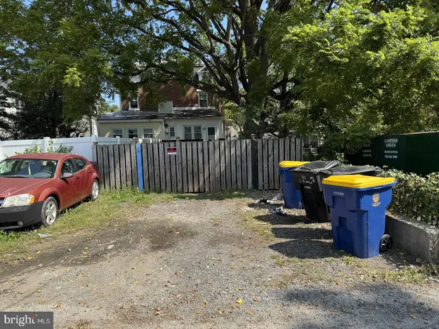 a view of a yard with a fire pit and a large tree