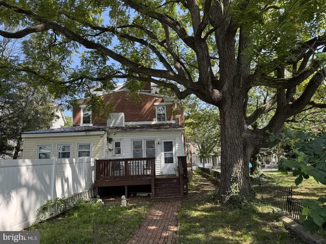 a view of a house with a tree in a yard