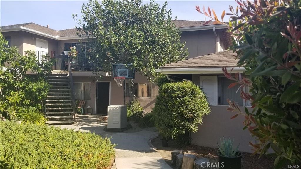 12230 Arrowhead Street Stanton, CA 90680 - Photo 3 of 5 a front view of a house with garden