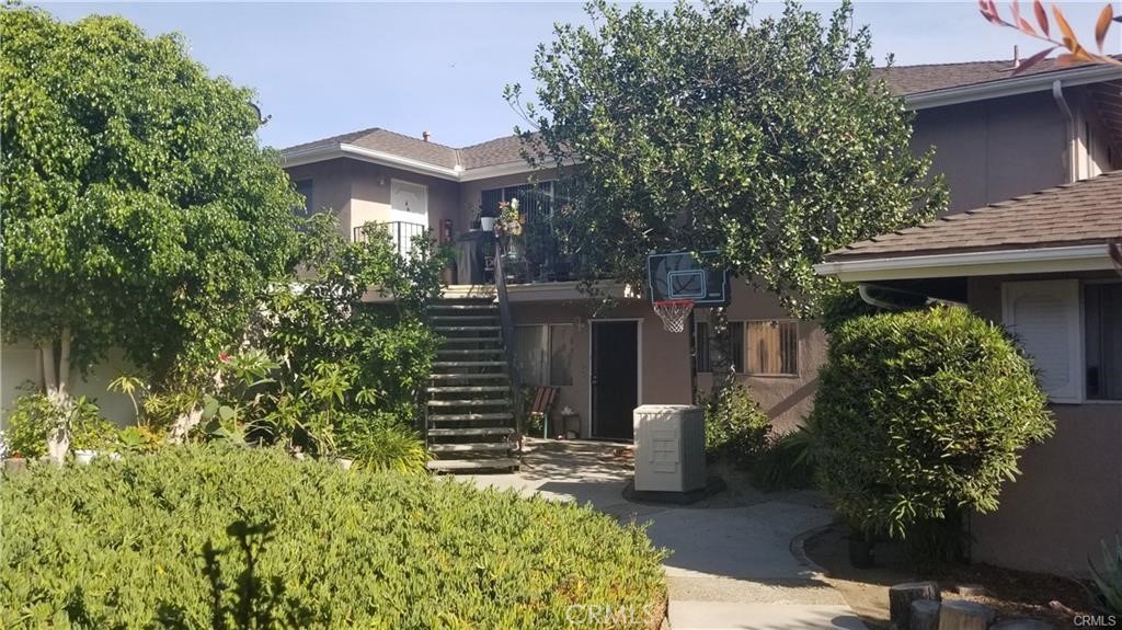 12230 Arrowhead Street Stanton, CA 90680 - Photo 4 of 5 a view of a house with potted plants