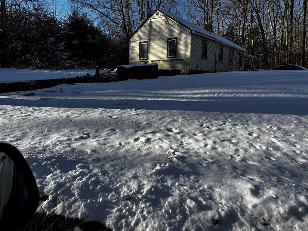 72 Northwest Schoolhouse Road Dudley, MA 01571 - Photo 1 of 5 a front view of a house with a yard
