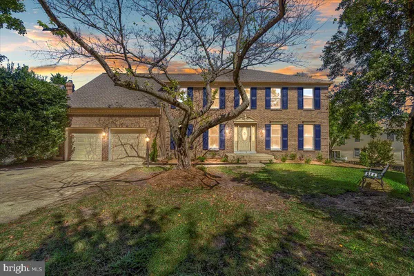 a front view of a house with yard and green space