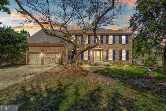 a front view of a house with yard and green space