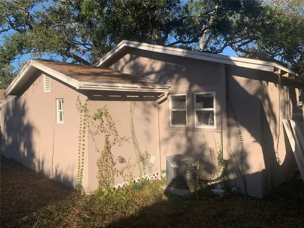 a side view of a house with a yard