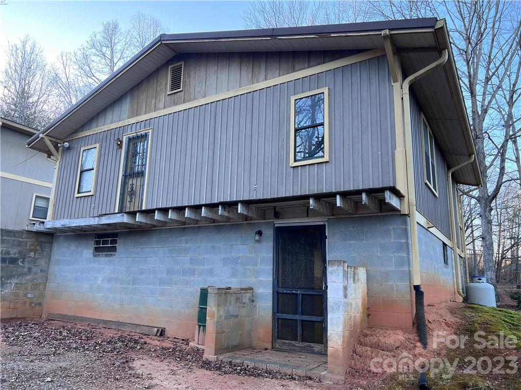 6756 Highway 9 Mill Spring, NC 28756 - Photo 7 of 46 a view of a small house with a door and wooden fence