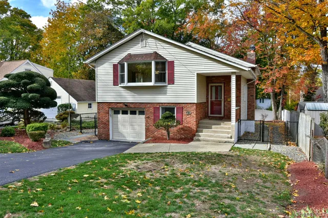 a front view of a house with a yard and porch